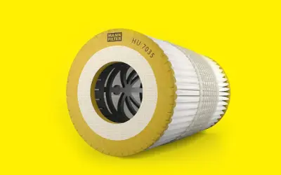 Mann Filter Ölfilter-Kartusche HU 7035 auf gelbem Hintergrund.